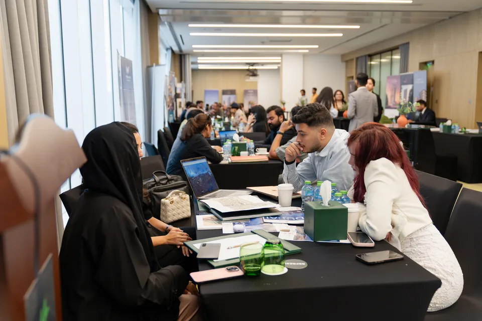 The expo floor, with consultations running at tables along the windows